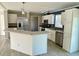 Modern kitchen with stainless steel appliances and an island at 8353 Normandy Dr, Weeki Wachee, FL 34613