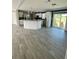 Open concept kitchen and dining area with wood-look flooring at 8353 Normandy Dr, Weeki Wachee, FL 34613