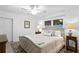 Spacious bedroom with king-size bed, nightstands, and ceiling fan at 401 Appian Ne Way, St Petersburg, FL 33704