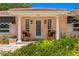 Inviting front entrance with columns, awning, and wicker chairs at 401 Appian Ne Way, St Petersburg, FL 33704