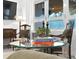 Glass-top coffee table with books and decor in the living room at 401 Appian Ne Way, St Petersburg, FL 33704