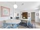 Open dining area with white table, blue chairs and kitchen views at 401 Appian Ne Way, St Petersburg, FL 33704