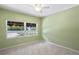 Guest bedroom with light green walls and large windows at 401 Appian Ne Way, St Petersburg, FL 33704
