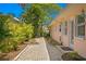 Brick pathway leading to the home's entrance, surrounded by tropical landscaping at 401 Appian Ne Way, St Petersburg, FL 33704
