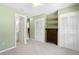 Guest bedroom with built-in shelving and adjacent bathroom at 401 Appian Ne Way, St Petersburg, FL 33704