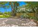 Brick paver patio with table and chairs, nestled amongst lush landscaping at 401 Appian Ne Way, St Petersburg, FL 33704