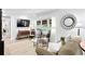 Spacious living area with a large TV and ample natural light at 401 Appian Ne Way, St Petersburg, FL 33704