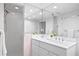 Modern bathroom with double vanity, glass shower, and plenty of light at 401 Appian Ne Way, St Petersburg, FL 33704