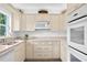 Clean kitchen featuring light wood cabinets and quartz countertops at 401 Appian Ne Way, St Petersburg, FL 33704