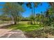 Landscaped front yard with lush green grass and a brick walkway at 401 Appian Ne Way, St Petersburg, FL 33704