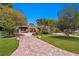 Exterior of a light pink house with a brick driveway and lush landscaping at 401 Appian Ne Way, St Petersburg, FL 33704