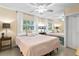Main bedroom with a ceiling fan and mirrored wall at 401 Appian Ne Way, St Petersburg, FL 33704