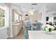 Open concept kitchen with island, light cabinets, and a dining area at 401 Appian Ne Way, St Petersburg, FL 33704
