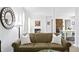 Comfortable living room featuring a brown sofa and white throw pillows at 401 Appian Ne Way, St Petersburg, FL 33704