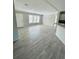 Spacious living room with wood-look floors and neutral walls at 8353 Normandy Dr, Weeki Wachee, FL 34613