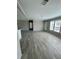 Open living room with gray wood-look flooring at 8353 Normandy Dr, Weeki Wachee, FL 34613