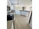 Open concept kitchen with island and stainless steel appliances at 8353 Normandy Dr, Weeki Wachee, FL 34613