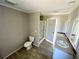 Bathroom with double vanity, walk-in shower, and toilet at 8353 Normandy Dr, Weeki Wachee, FL 34613