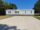 Single-wide manufactured home with gray siding at 8353 Normandy Dr, Weeki Wachee, FL 34613