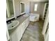 Bathroom boasts a corner soaking tub and double vanity at 8353 Normandy Dr, Weeki Wachee, FL 34613