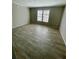Bright bedroom with wood-look floors and large windows at 8353 Normandy Dr, Weeki Wachee, FL 34613