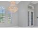 Elegant entryway with a crystal chandelier and double doors at 6218 Bridleford Dr, Wesley Chapel, FL 33545