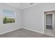 Bright bedroom with grey walls, carpet, and window at 6218 Bridleford Dr, Wesley Chapel, FL 33545
