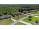 Aerial view of house and property, wooded area nearby at 6218 Bridleford Dr, Wesley Chapel, FL 33545