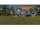House exterior at dusk, Mediterranean style, lush landscaping at 6218 Bridleford Dr, Wesley Chapel, FL 33545