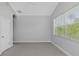 Bright bedroom with large window and carpet flooring at 6218 Bridleford Dr, Wesley Chapel, FL 33545