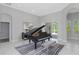 Spacious music room with grand piano and view to patio at 6218 Bridleford Dr, Wesley Chapel, FL 33545