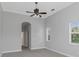 Spacious bedroom with ceiling fan, large windows, and neutral colors at 6218 Bridleford Dr, Wesley Chapel, FL 33545