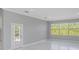 Bright living room with French doors and marble flooring at 6218 Bridleford Dr, Wesley Chapel, FL 33545