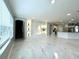 Living room with marble floors, built-ins, and views to kitchen and stairs at 6218 Bridleford Dr, Wesley Chapel, FL 33545