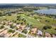 An aerial view of the golf course community with a lake in the distance at 33724 Americana Ave, Dade City, FL 33525