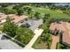 An aerial view of the home on a well-manicured lot near a golf course and pond at 33724 Americana Ave, Dade City, FL 33525