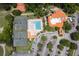 Aerial view of community amenities, including a pool, tennis courts, clubhouse, and ample parking at 33724 Americana Ave, Dade City, FL 33525