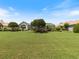 Spacious backyard featuring a screened lanai and mature landscaping at 33724 Americana Ave, Dade City, FL 33525