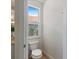 Bright half bath with a window, offering natural light and a view of the exterior at 33724 Americana Ave, Dade City, FL 33525