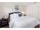Comfortable bedroom featuring plush white bedding, a modern nightstand, and a serene atmosphere at 33724 Americana Ave, Dade City, FL 33525