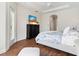 Bedroom featuring a dark wood dresser with TV and access to the outside, offering a peaceful retreat at 33724 Americana Ave, Dade City, FL 33525