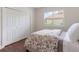 Bedroom with hardwood floors, a window providing natural light, and a closet at 33724 Americana Ave, Dade City, FL 33525