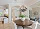 Dining room with wood table, seating for four, chandelier, and view to a screened patio at 33724 Americana Ave, Dade City, FL 33525