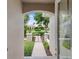 View of the home's entrance, with a landscaped pathway and iron gate at 33724 Americana Ave, Dade City, FL 33525