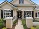 Elegant entryway with wrought iron gate, manicured landscaping, and stylish lighting at 33724 Americana Ave, Dade City, FL 33525