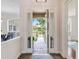 Grand entrance with decorative glass doors offering a view of the meticulously landscaped front yard and gated entrance at 33724 Americana Ave, Dade City, FL 33525