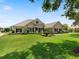 Charming single-story home with a well-manicured lawn, mature trees, and beautiful landscaping at 33724 Americana Ave, Dade City, FL 33525
