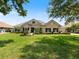 Beautiful single-story home with lush green lawn and professional landscaping at 33724 Americana Ave, Dade City, FL 33525