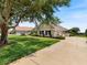 Charming single-story home with lush lawn, mature tree and well-maintained landscaping at 33724 Americana Ave, Dade City, FL 33525