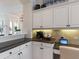 Kitchen nook area with granite countertops, white cabinets, and stainless steel appliances at 33724 Americana Ave, Dade City, FL 33525
